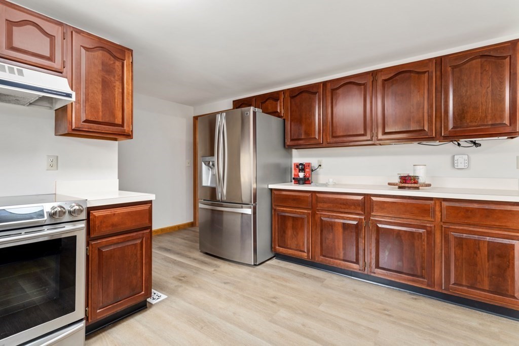 4 Darrell Drive North Reading, MA 01864 - Photo 16 of 41 a kitchen with stainless steel appliances granite countertop wooden cabinets a stove a sink and dishwasher