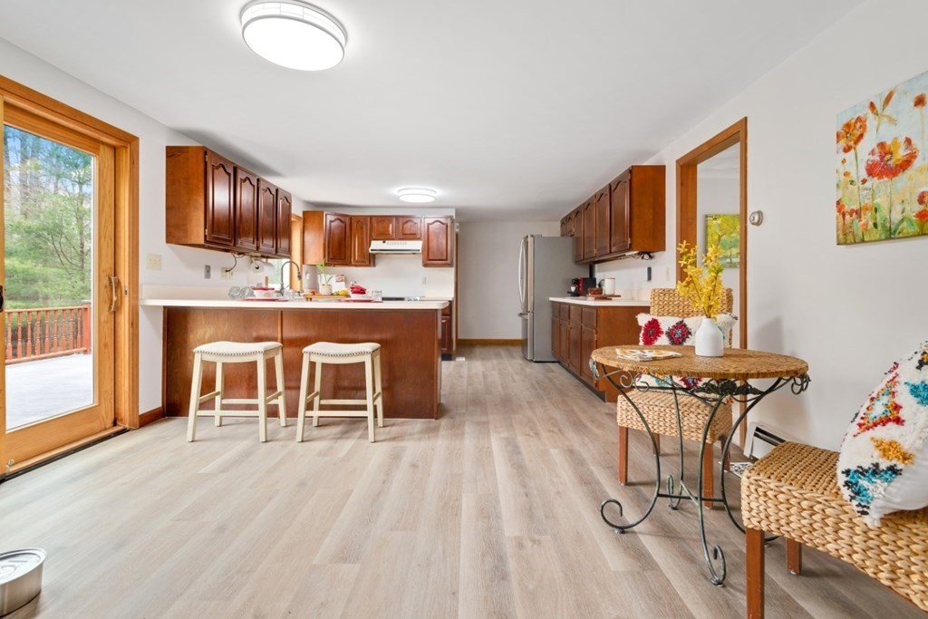 4 Darrell Drive North Reading, MA 01864 - Photo 17 of 41 a view of a dining room with furniture a chandelier and wooden floor