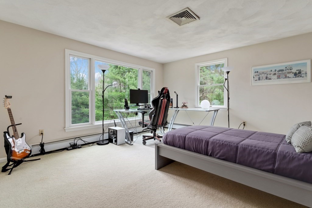 4 Darrell Drive North Reading, MA 01864 - Photo 29 of 41 a living room with a bed furniture and a large window