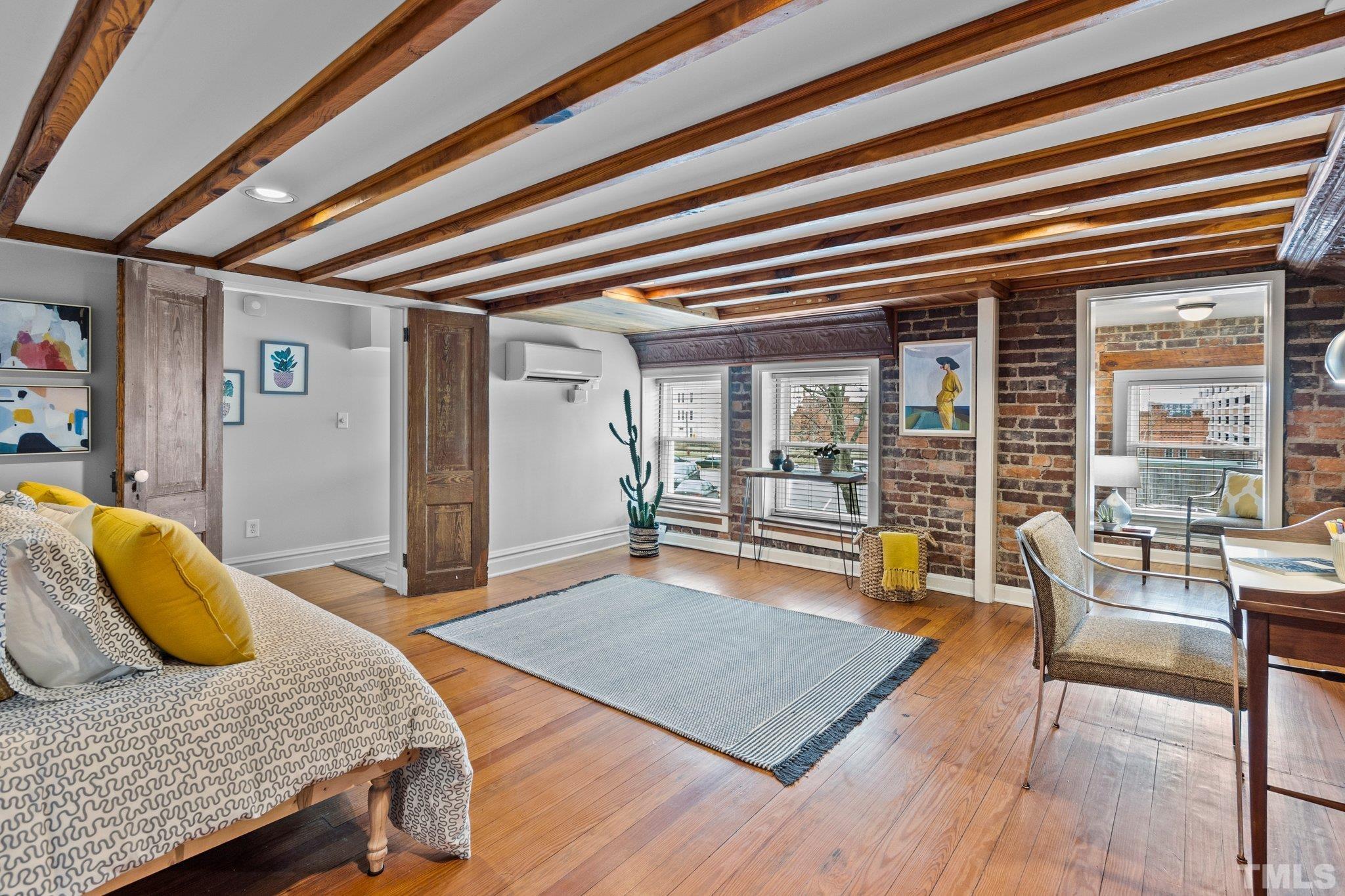 323 West Main Street, Unit J Durham, NC 27701 - Photo 20 of 36 a bedroom with furniture and a large window
