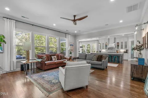 a kitchen with stainless steel appliances granite countertop a stove and a large window
