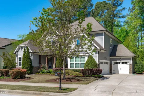 a house that has a tree in front of it