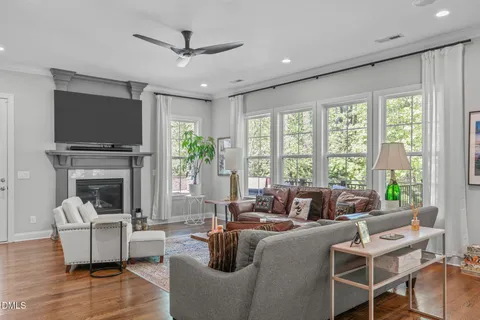a spacious bathroom with a double vanity sink a large mirror a bathtub and next to a window
