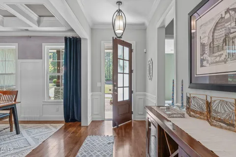 a view of a dining room with furniture and chandelier