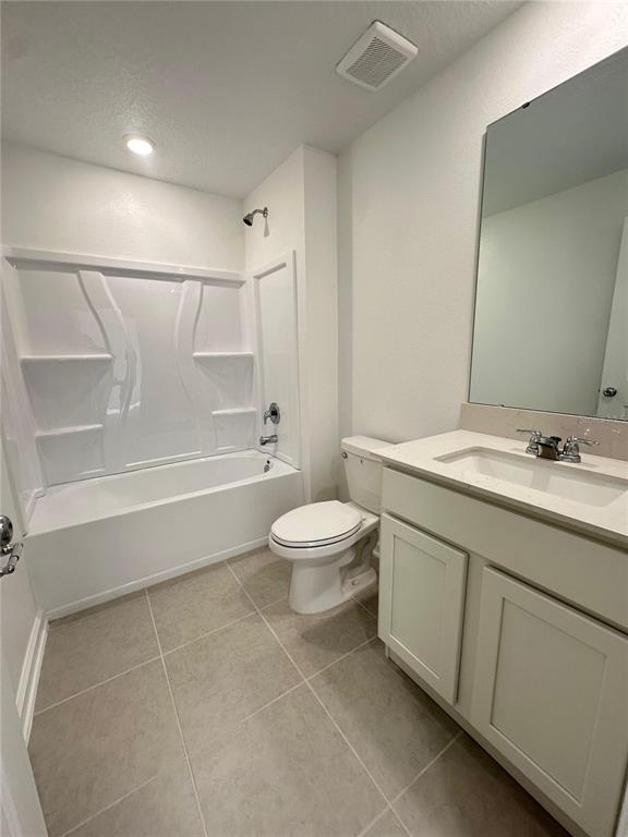 2117 Lasso Loop Eagle Lake, FL 33839 - Photo 23 of 41 a bathroom with a granite countertop sink a toilet and a bathtub