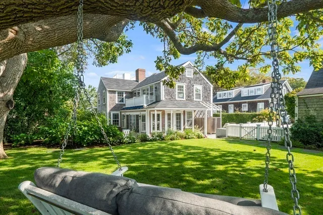a front view of a house with a yard table and chairs