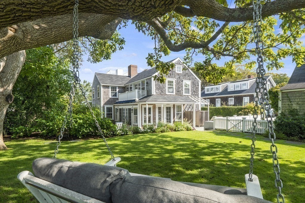 a front view of a house with a yard table and chairs