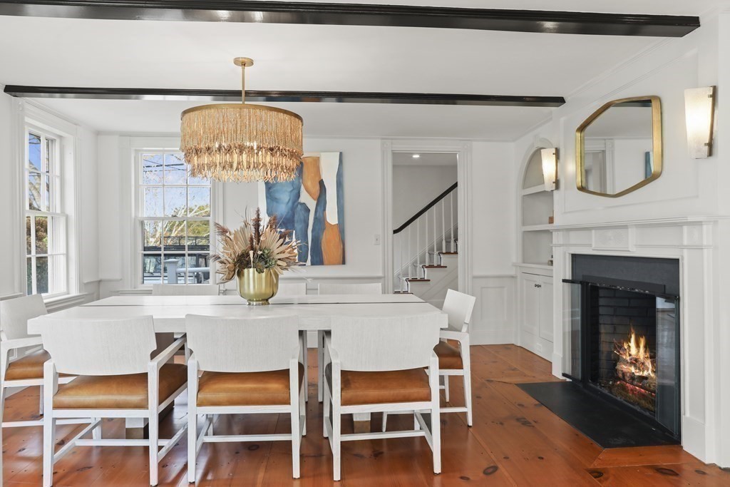 134 Main Street Nantucket, MA 02554 - Photo 12 of 42 a dining room with furniture and a fireplace