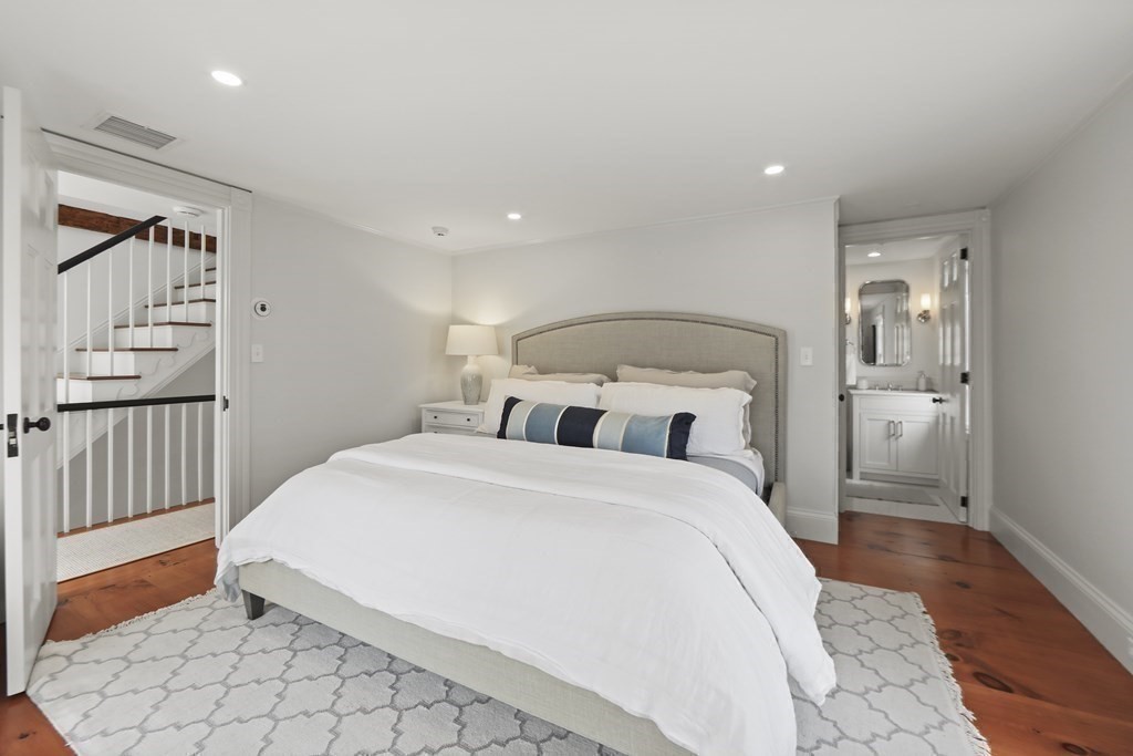 134 Main Street Nantucket, MA 02554 - Photo 23 of 42 a spacious bedroom with a bed and a view of bathroom