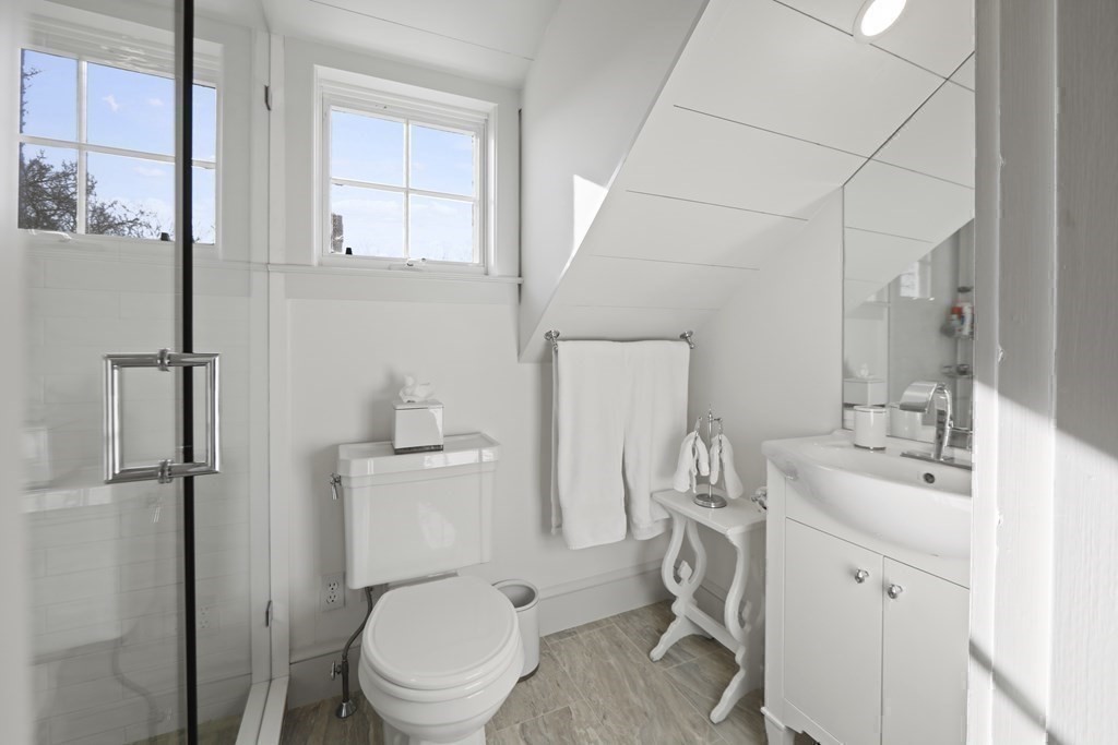 134 Main Street Nantucket, MA 02554 - Photo 26 of 42 a bathroom with a toilet a sink and a mirror