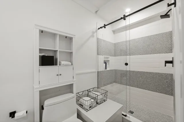 a view of a storage and utility room with wooden floor