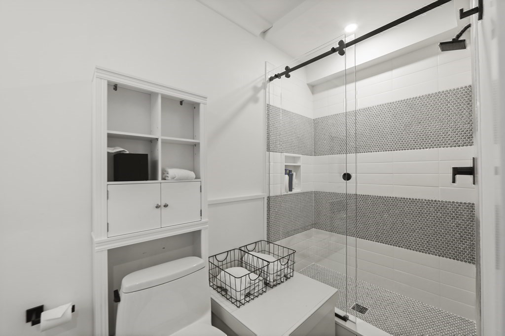 134 Main Street Nantucket, MA 02554 - Photo 32 of 42 a bathroom with a bathtub and a shower