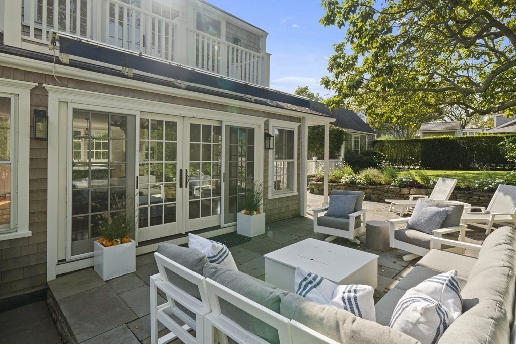 134 Main Street Nantucket, MA 02554 - Photo 35 of 42 a view of a patio with couches table and chairs and potted plants