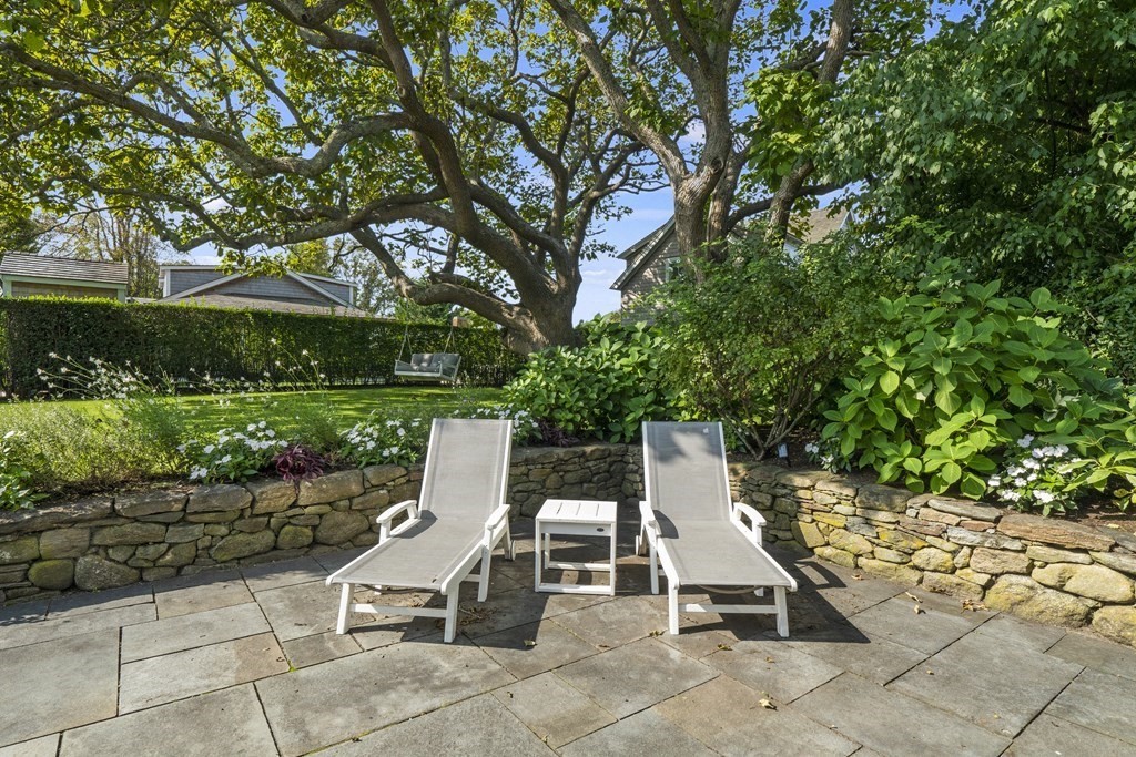 134 Main Street Nantucket, MA 02554 - Photo 36 of 42 a view of a chairs and tables in the backyard