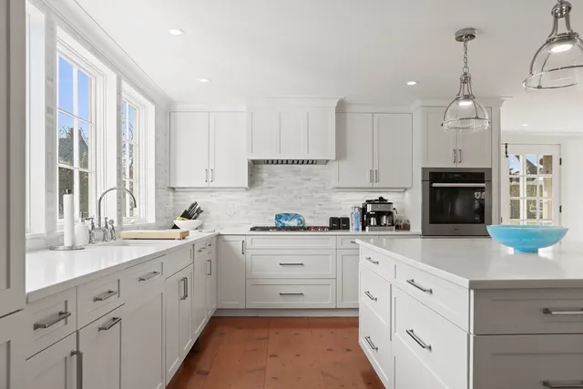 a kitchen with cabinets appliances a sink and a counter top space