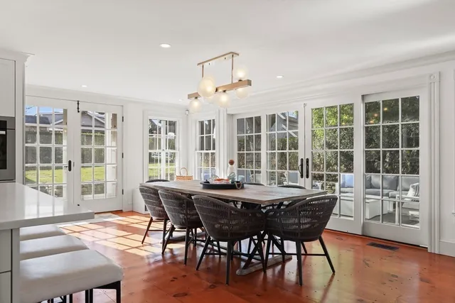 a dining room with furniture window and wooden floor
