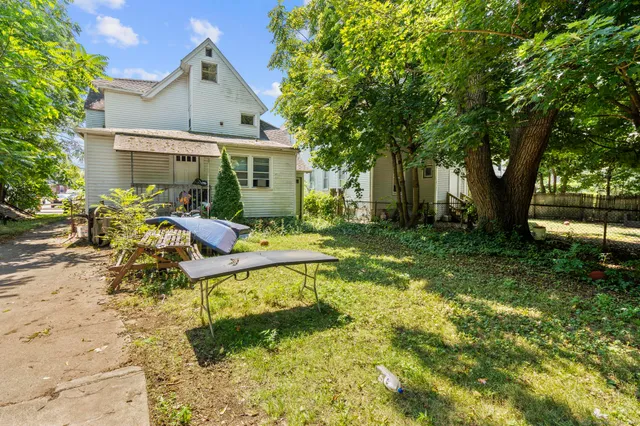 a view of backyard of house with green space