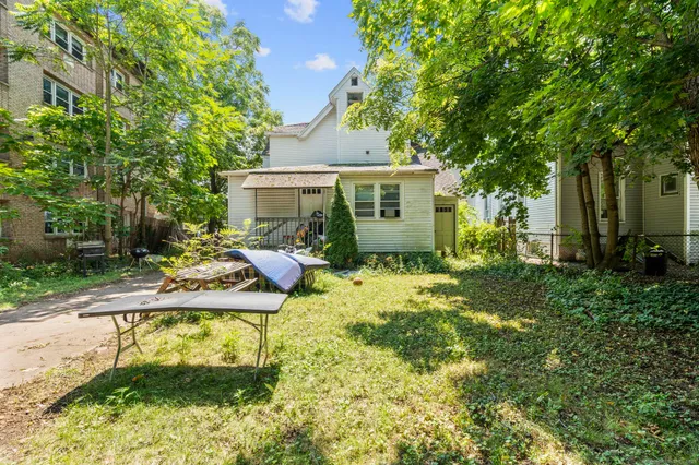 a view of a house with backyard and sitting area