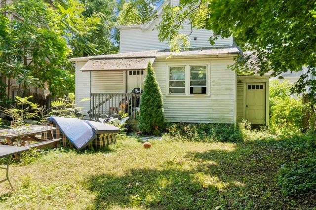 a view of a house with backyard and sitting area