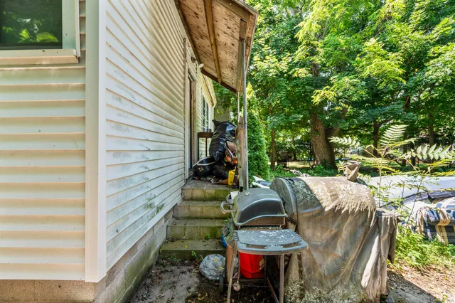 a view of backyard with outdoor seating and trees