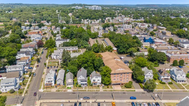 an aerial view of residential houses with outdoor space and parking