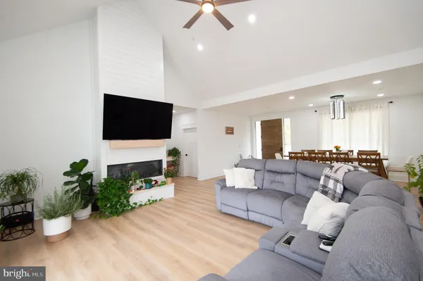a kitchen with a sink appliances and wooden floor