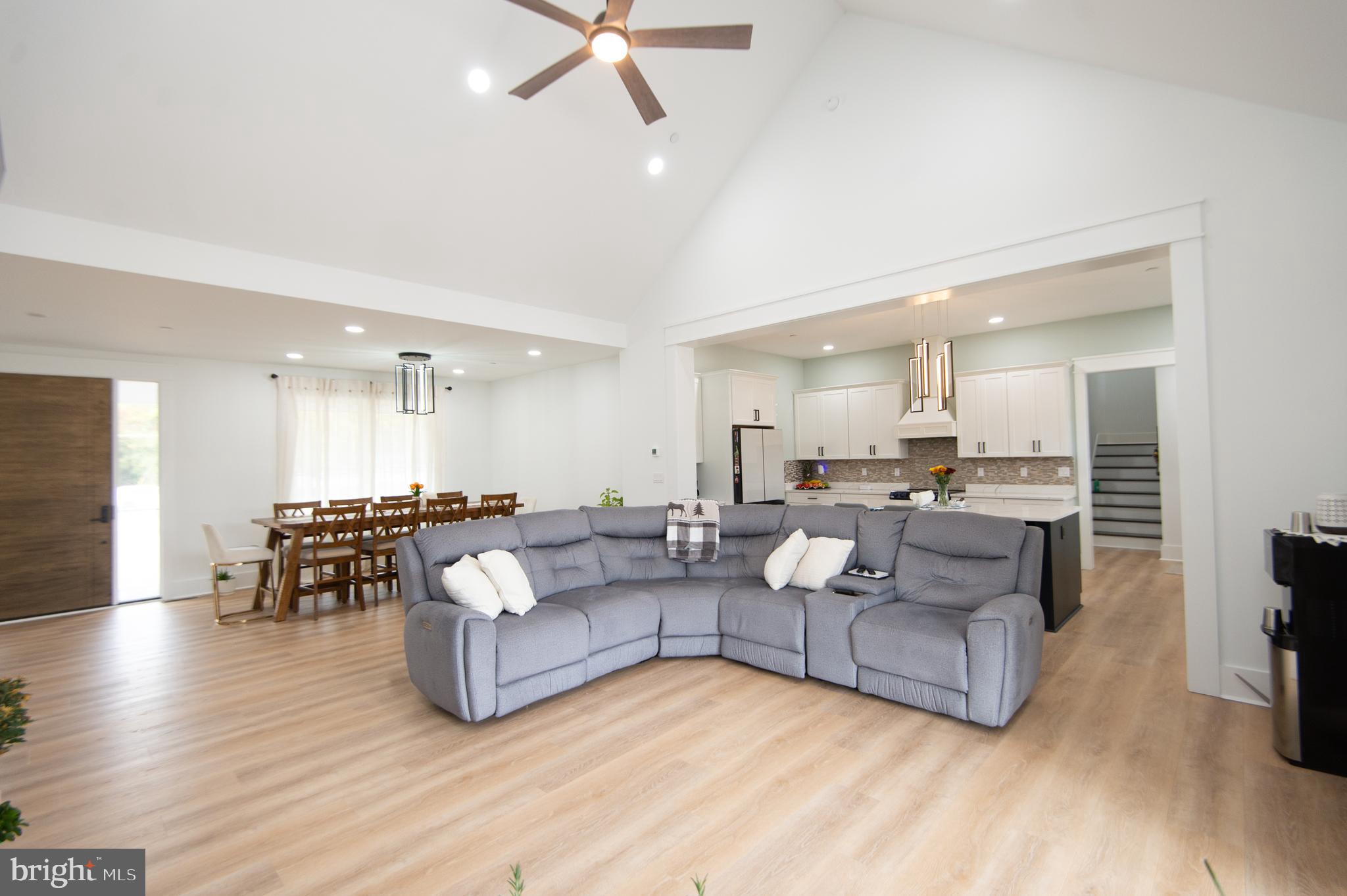 9509 Rum Ridge Road Delmar, MD 21875 - Photo 12 of 76 a living room with couches and kitchen view with wooden floor