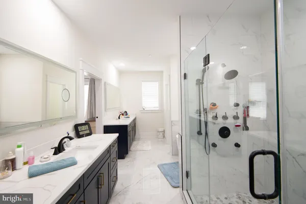 a bathroom with a sink double vanity and a mirror