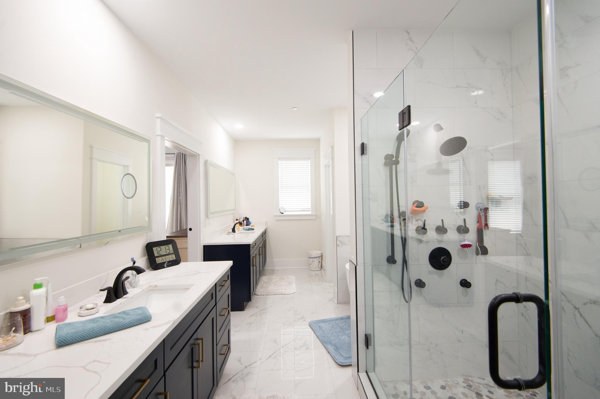 9509 Rum Ridge Road Delmar, MD 21875 - Photo 26 of 76 a bathroom with a double vanity sink mirror and shower