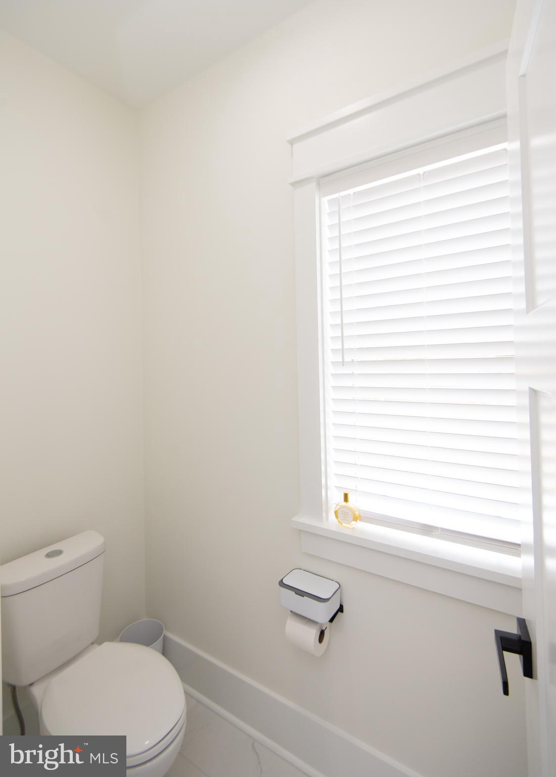 9509 Rum Ridge Road Delmar, MD 21875 - Photo 27 of 76 a bathroom with a toilet a sink and a window
