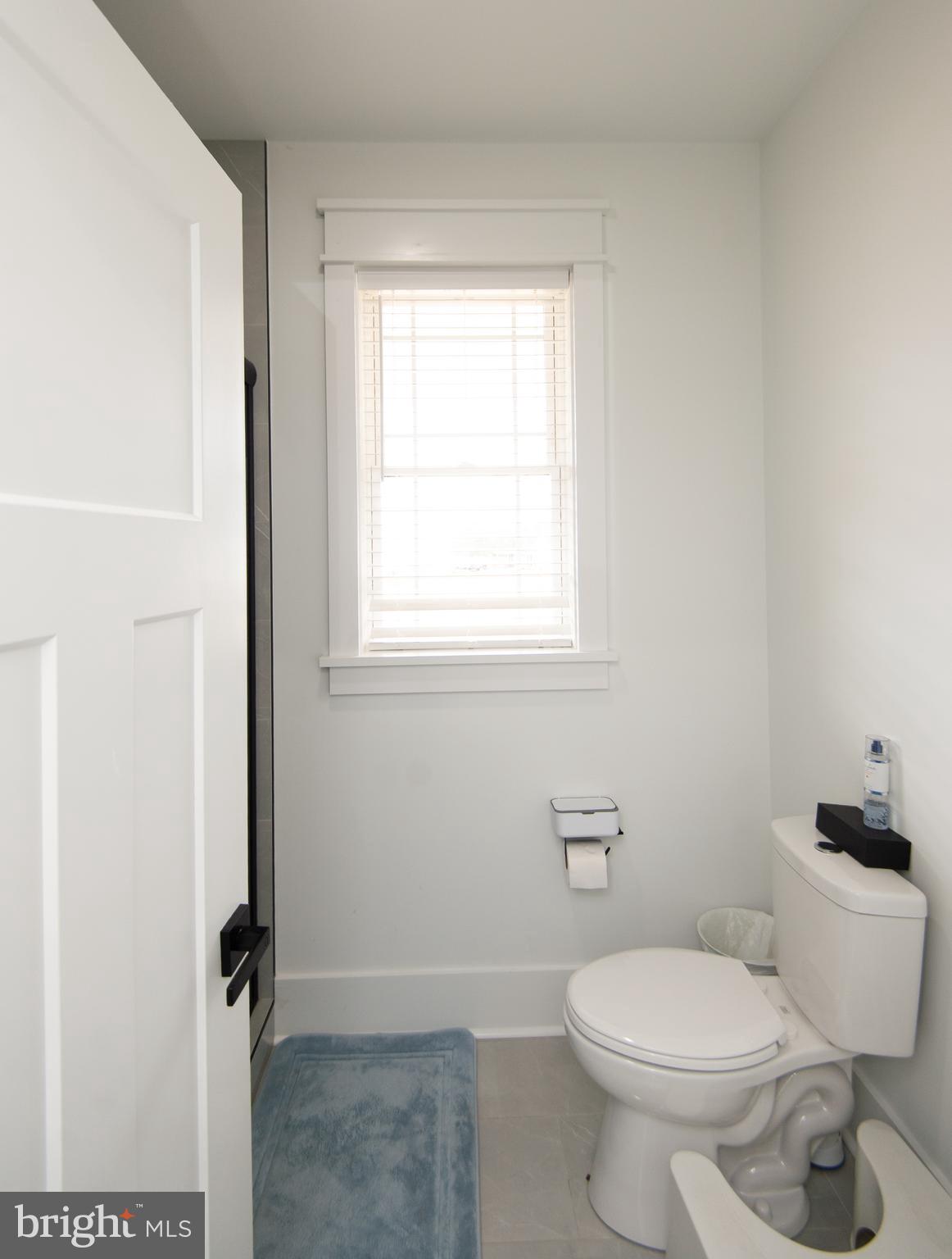 9509 Rum Ridge Road Delmar, MD 21875 - Photo 35 of 76 a white toilet sitting next to a bathroom sink and vanity