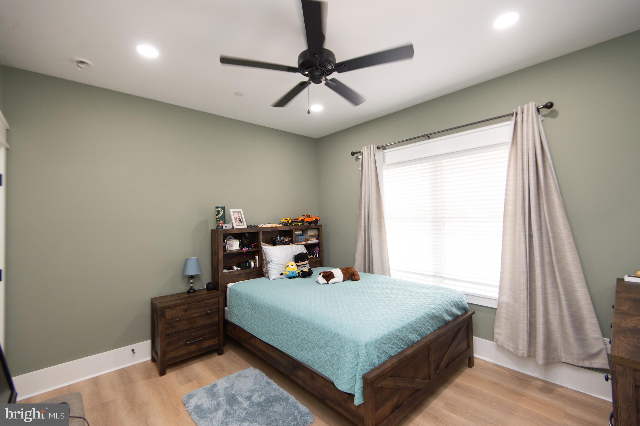 9509 Rum Ridge Road Delmar, MD 21875 - Photo 37 of 76 a bedroom with a bed and a chandelier