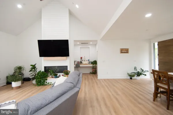 a kitchen with a stove a sink a dining table and chairs