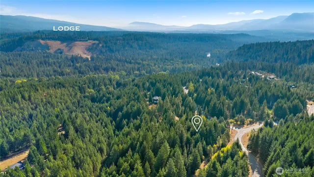 a view of a lake and green field