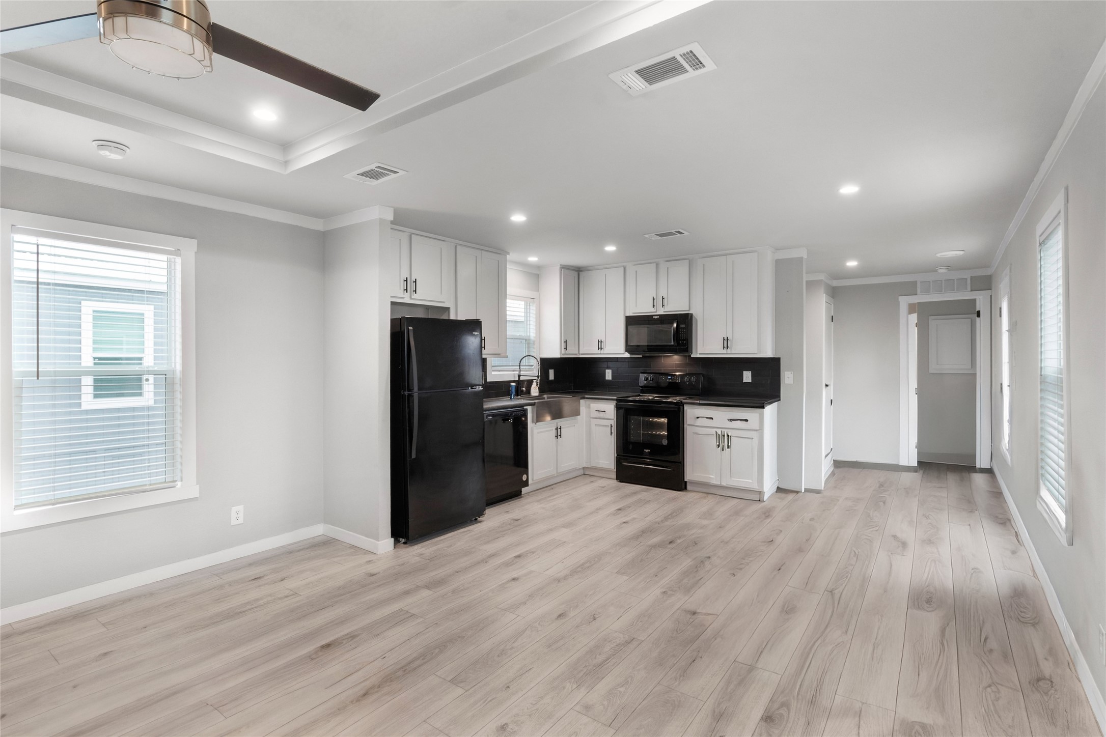 119 Mooney Road Pearland, TX 77581 - Photo 5 of 25 a kitchen with a refrigerator and a microwave