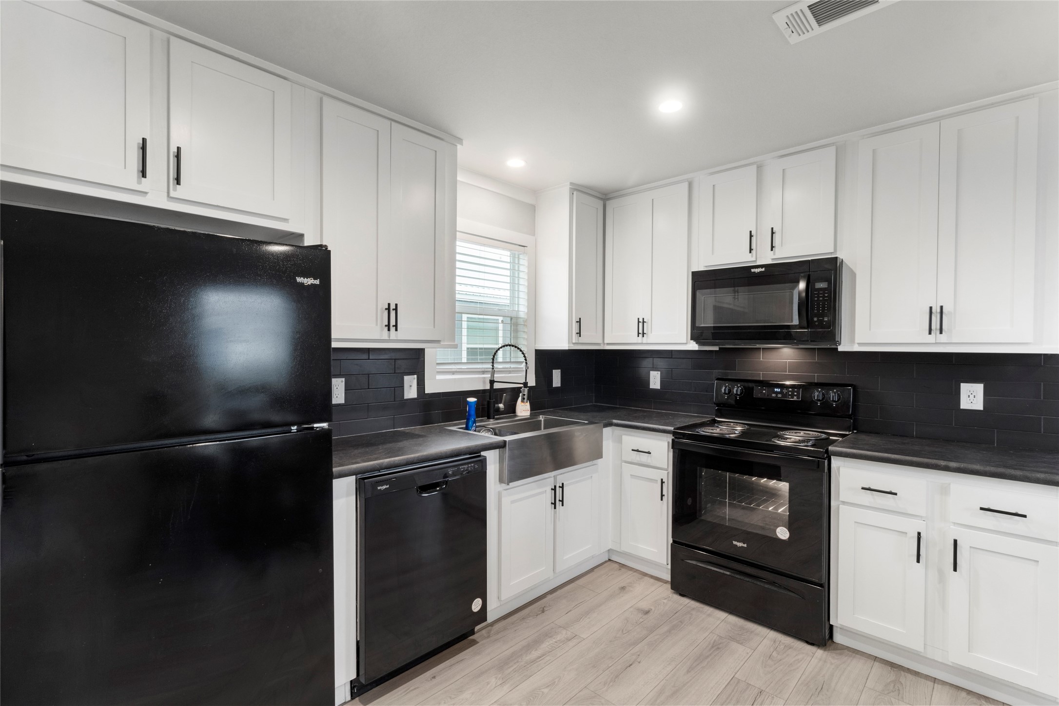 119 Mooney Road Pearland, TX 77581 - Photo 6 of 25 a kitchen with a sink and steel appliances