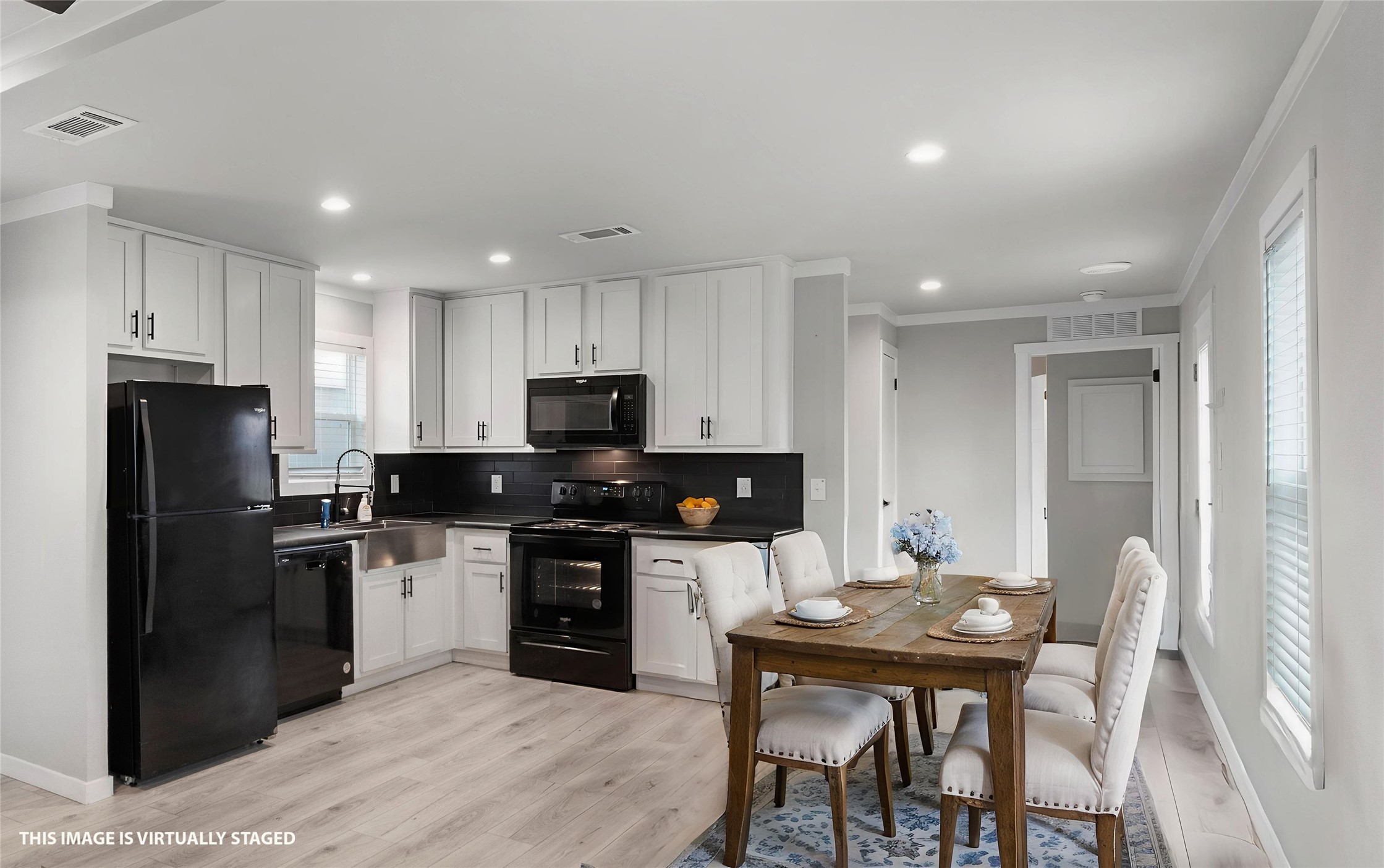 119 Mooney Road Pearland, TX 77581 - Photo 8 of 25 a kitchen with stainless steel appliances kitchen island granite countertop a refrigerator a stove a sink a dining table and chairs