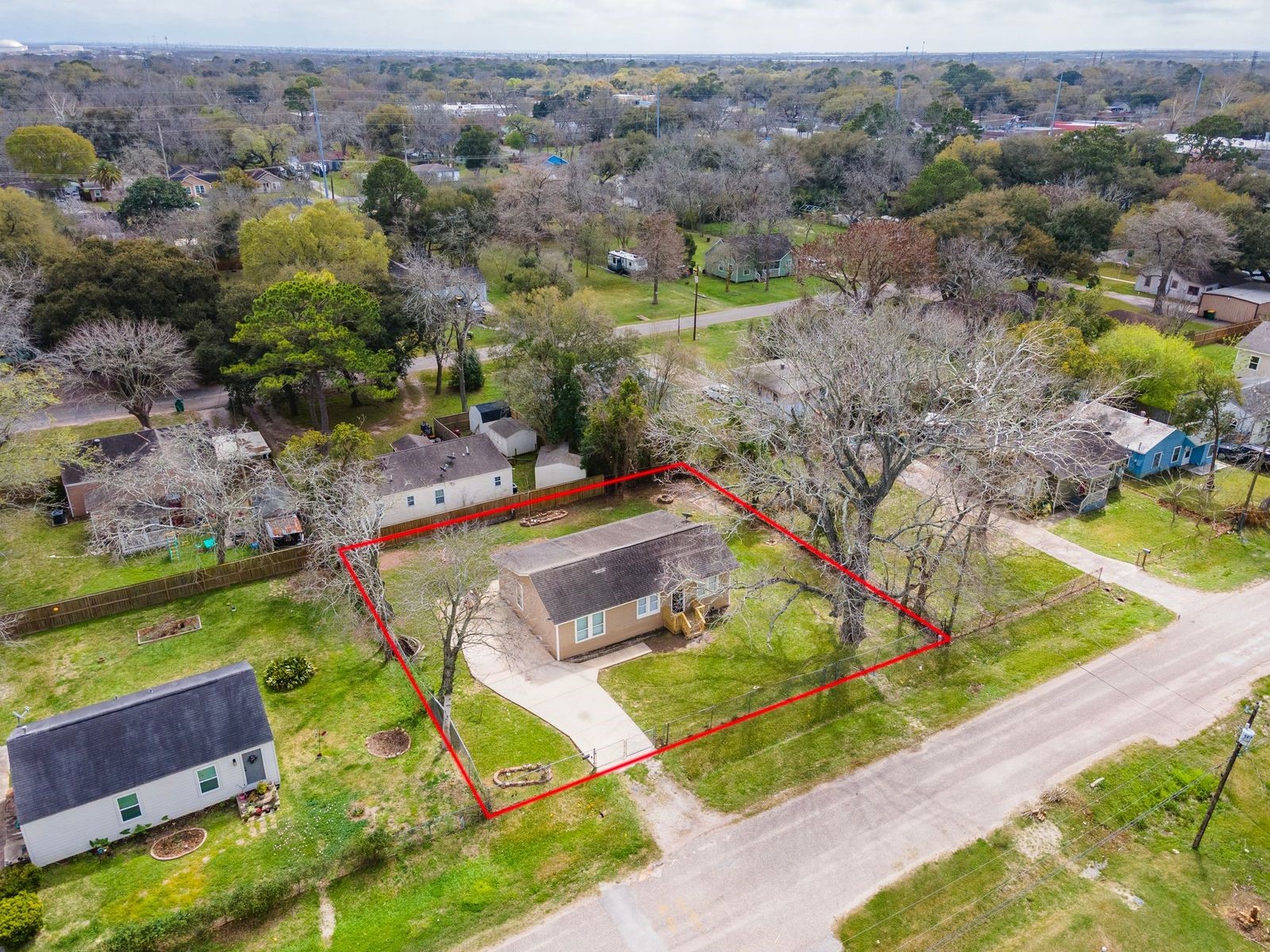 an aerial view of a house with a garden and lake view