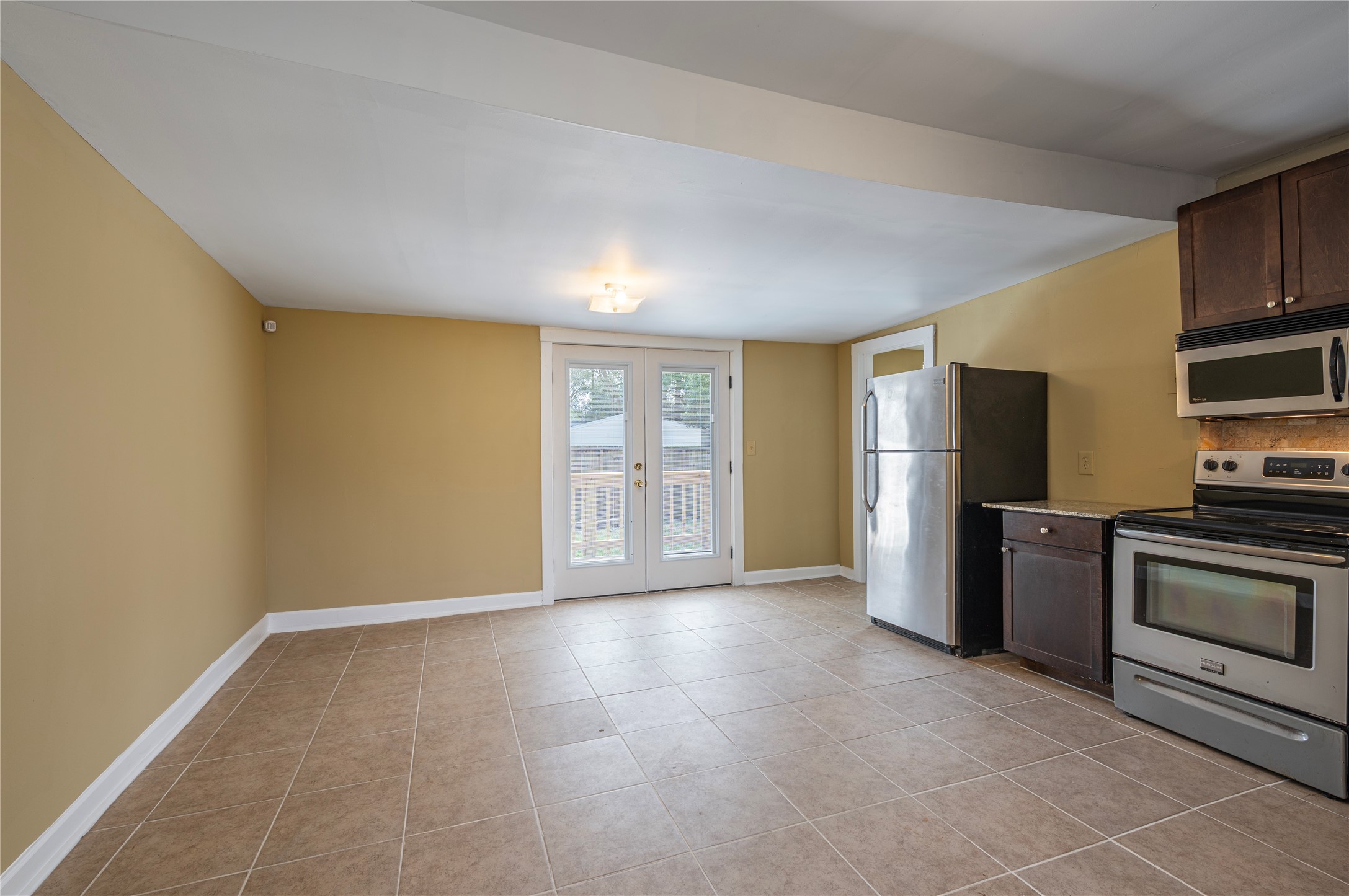 805 Chestnut Street La Marque, TX 77568 - Photo 12 of 26 a view of an empty room with a fireplace and a window