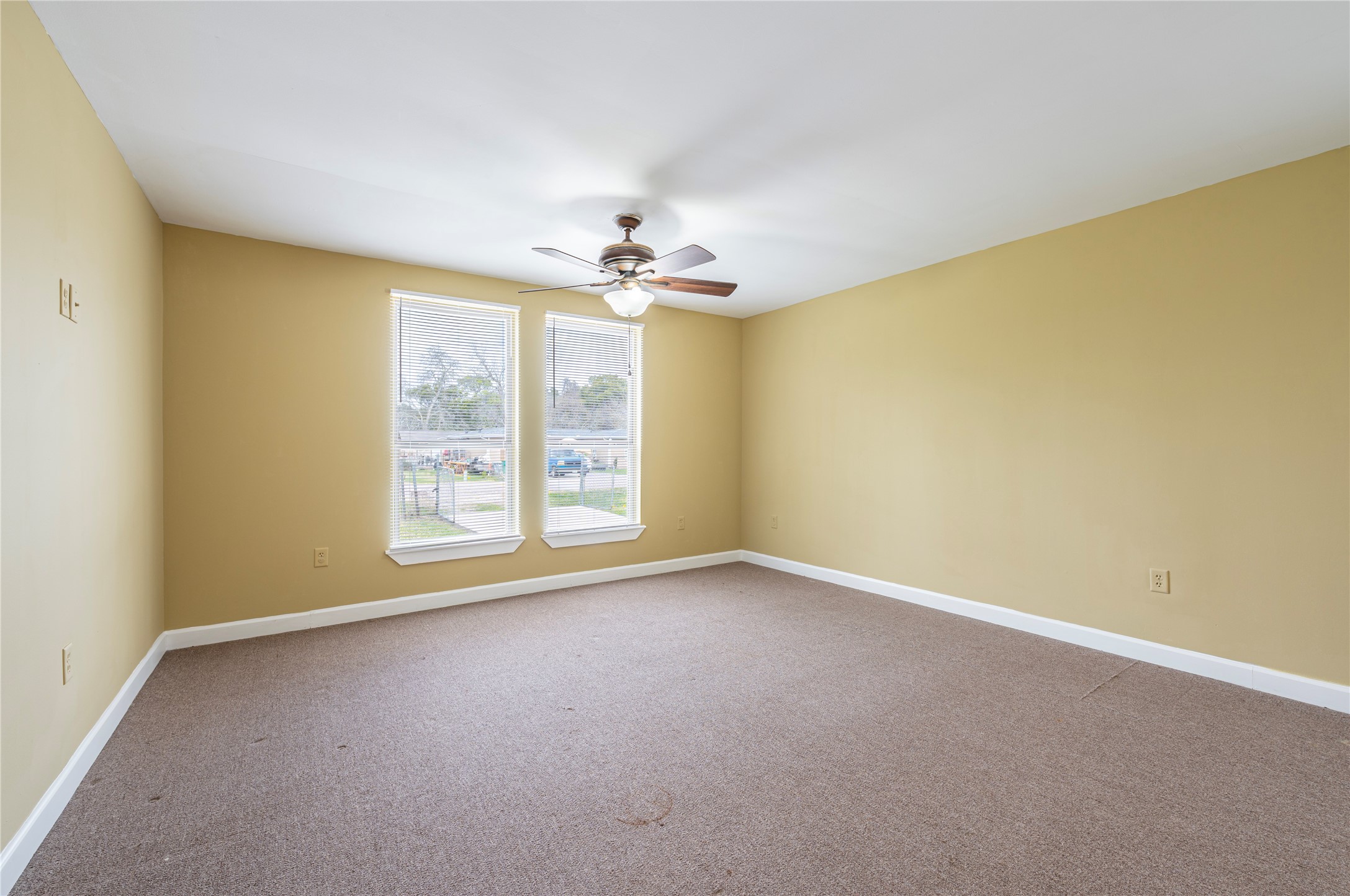 805 Chestnut Street La Marque, TX 77568 - Photo 3 of 26 an empty room with windows and chandelier fan