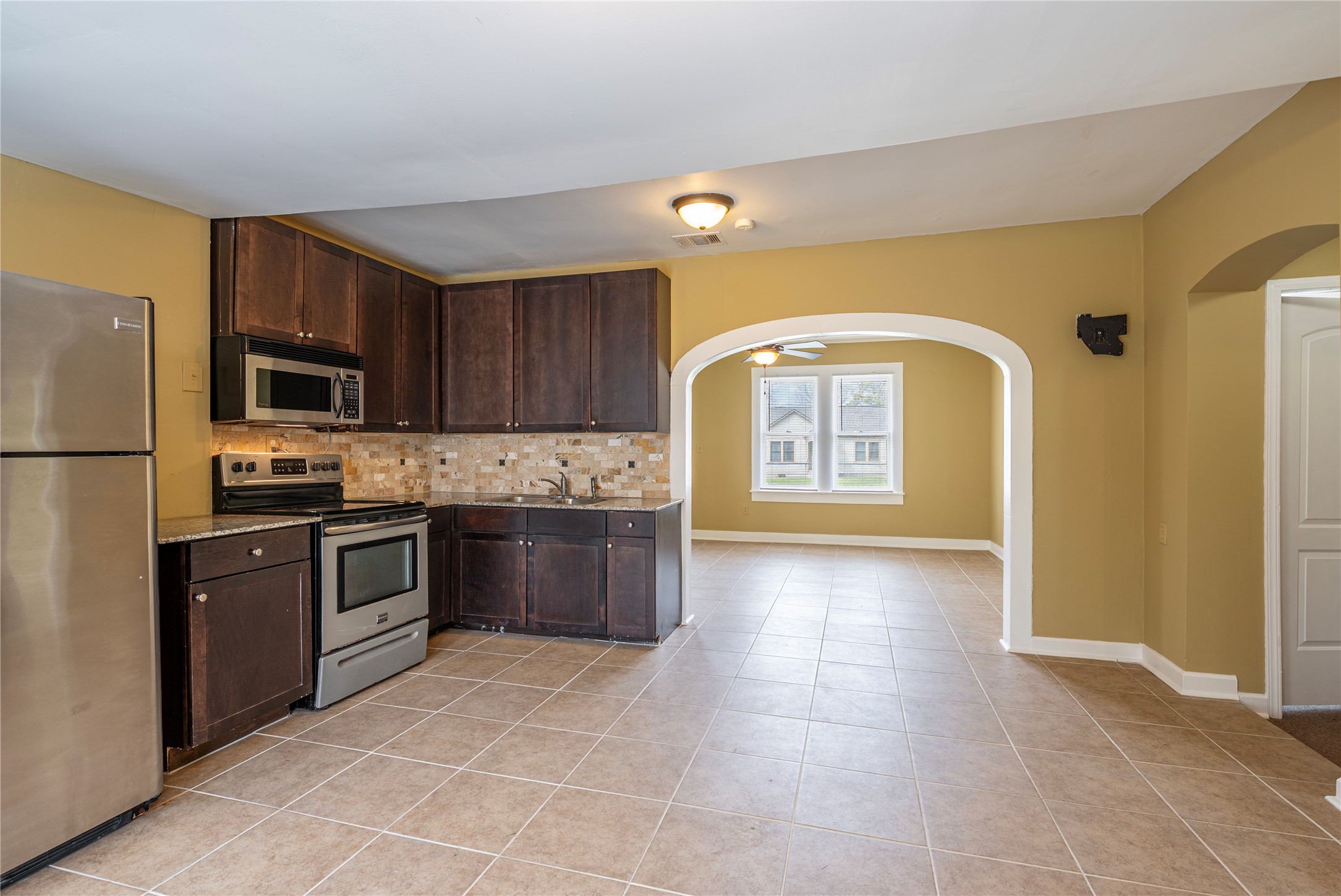 805 Chestnut Street La Marque, TX 77568 - Photo 9 of 26 a large kitchen with a stove a refrigerator and a sink