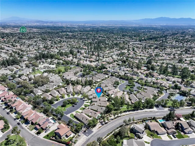 a view of a balcony with chairs and a potted plant