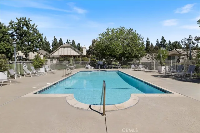 a swimming pool with outdoor seating and yard