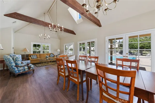 a dining room with furniture a rug and a chandelier