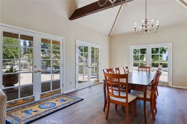a living room with furniture large window and wooden floor
