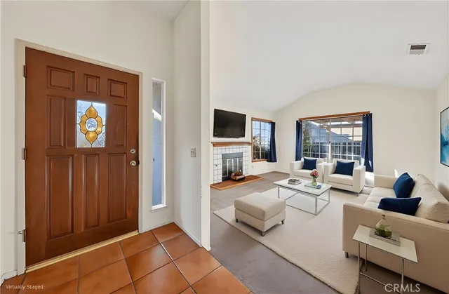 a living room with furniture fireplace and flat screen tv