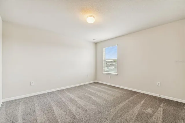 a view of a big room with a balcony and yard