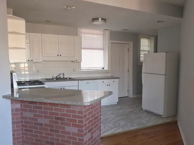a kitchen with stainless steel appliances granite countertop a sink and cabinets