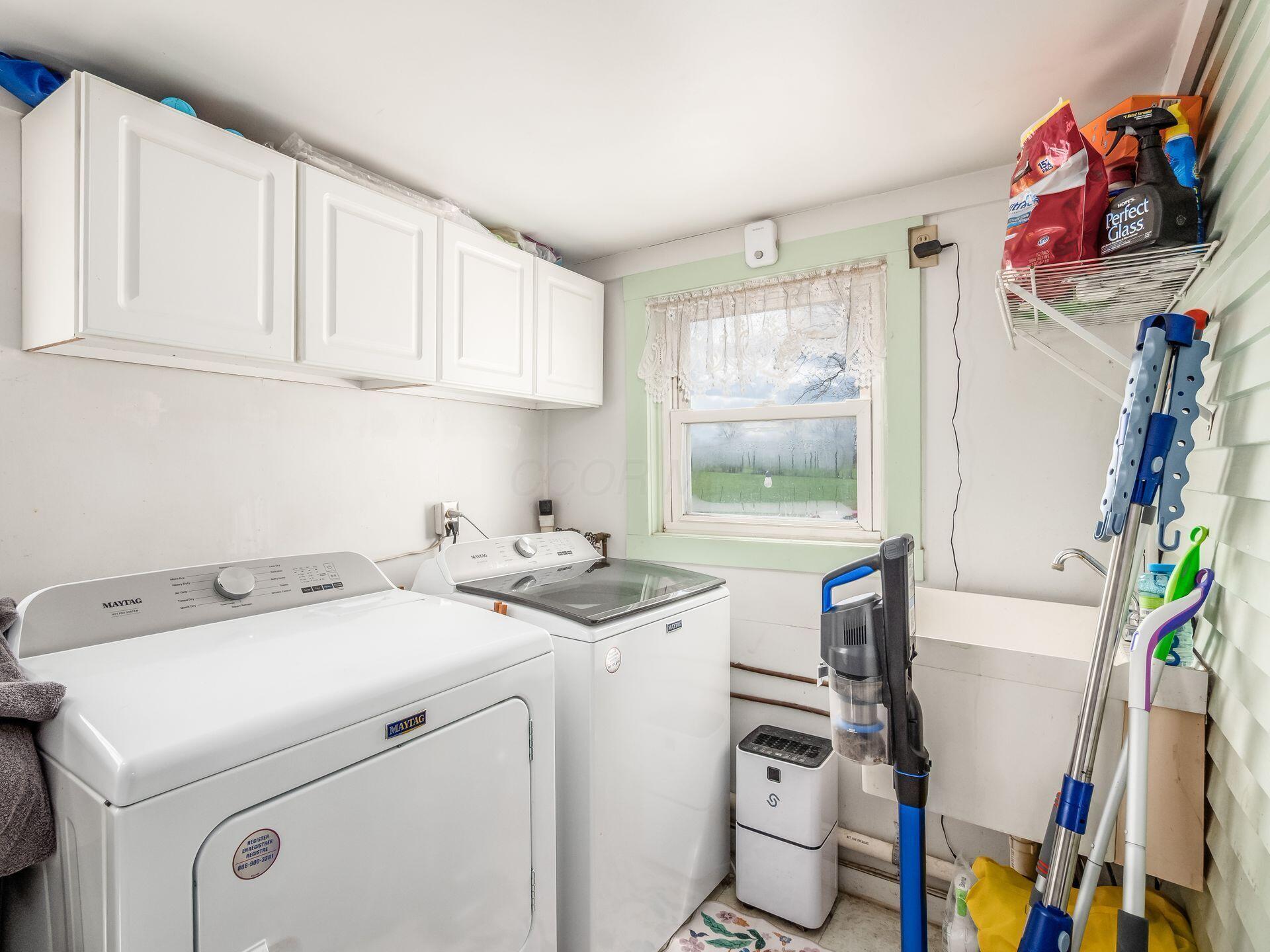 9557 Marysville Road Ostrander, OH 43061 - Photo 15 of 39 main floor utility room with cabinet storage