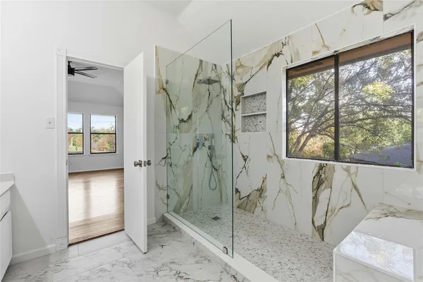 a bathroom with a bathtub and a shower